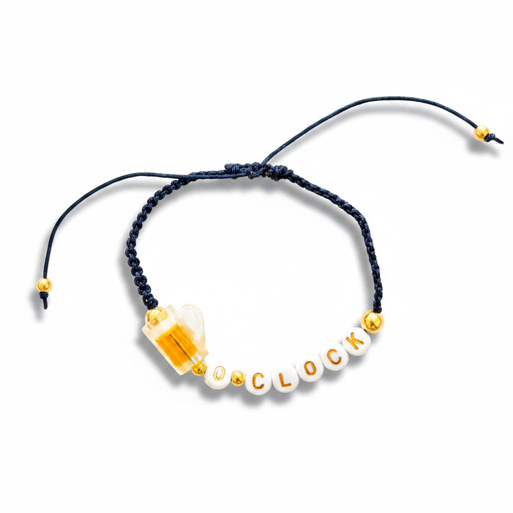Bracelet with letters spelling BEER 'O'CLOCK' on a white background