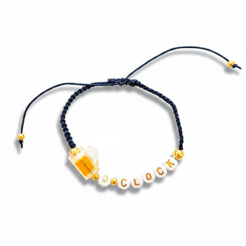 Bracelet with letters spelling BEER 'O'CLOCK' on a white background