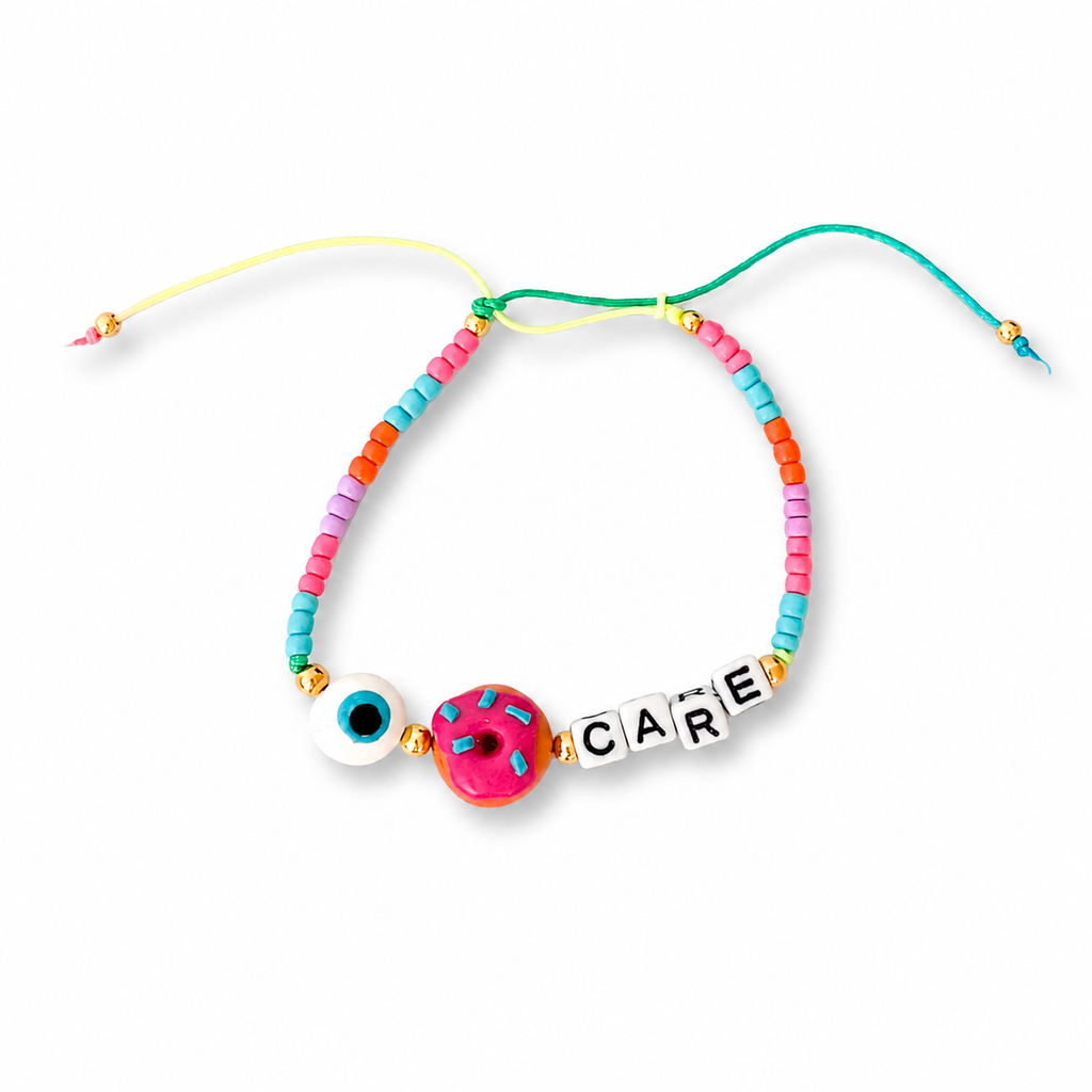 Colorful beaded bracelet with a 'CARE' charm on a white background